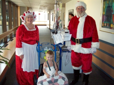 Jimmie Bass enjoys a visit from Mr. and Mrs. Clause in the hospital. 