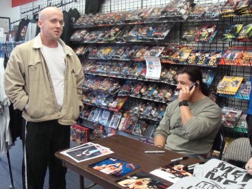 Independent Wrestler Michael Morbid waits while Al Snow calls Morbid’s girlfriend, who wanted to attend the signing, but was unable to because of her work schedule.