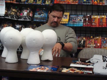 Al Snow signs ‘heads’ while chatting with the owners of The Fan Shop about the local wrestling scene, as well as the goings on in WWE and TNA.