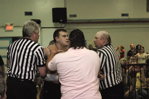 Dave Vaughn is restrained from attacking Kahyman. The match that the fans have been clamoring for, Vaughn vs. Kahyman is just around the corner. (Photo Credit by Mike Van Hoogstratt