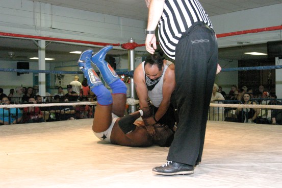Blunt gets nasty as he chokes the Champ in the middle of ring.
