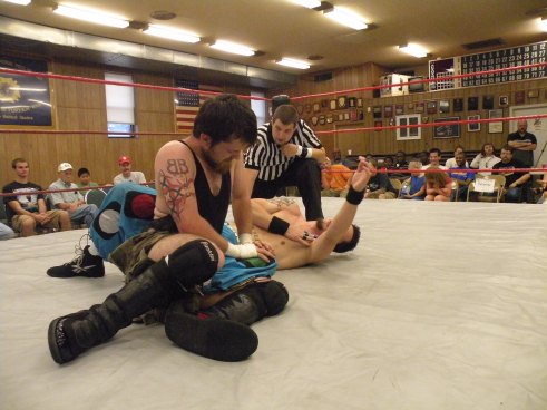 Neil “Diamond Cutter works on Billy McNeil’s leg early in the match(Photo credit Brian “Flair” Kelley)