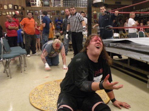 Ian Rotten stalks Mephisto after he throws him on a board of tacks. (Photo credit Brian “Flair” Kelley)