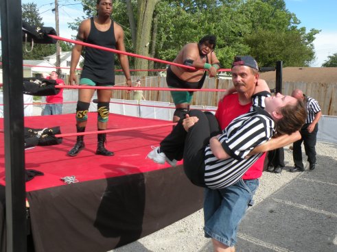 After Walker speared the female ref, the Future Donovan Ruddick came into to restrain Walker from his destruction. Our hearts to go out to the ref.   (Photo Credit Brian “Flair” Kelley)