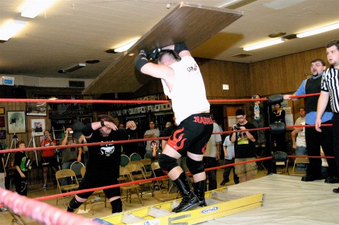 Mephisto throws a chair on top of Napalm. (Photo Credit Michael R Van Hoogstraat)