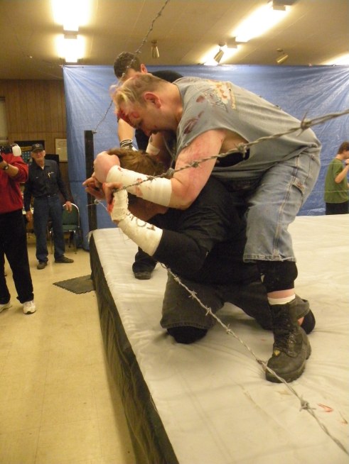 Ian Rotten tortures Mephisto with Barb Wire(Photo Credit Brian “Flair” Kelley)
